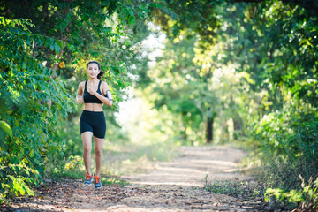 Young fitness woman running on a rural road. Sport woman running