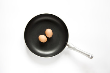 Top View frying pan and eggs on white background