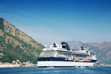 Fototapeta na wymiar Cruise liner ship swimming at blue adriatic sea, mountains landscape