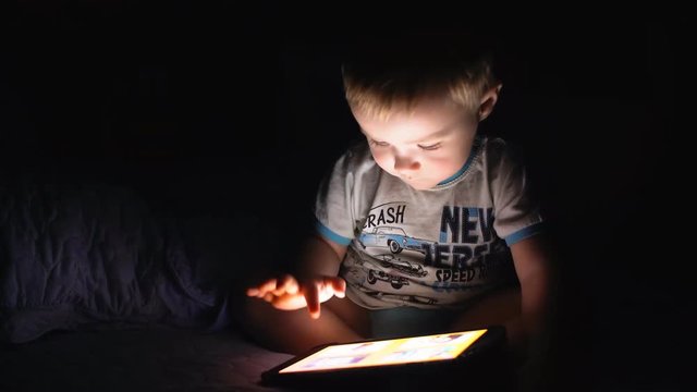 Little boy uses the tablet. 4K