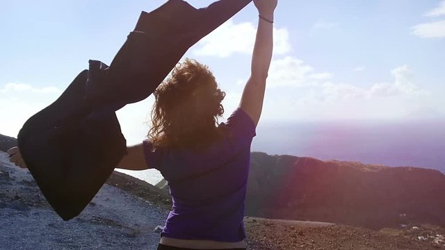 peaceful and happy woman with raised arms in the wind: freedom, summer
