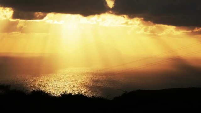 sunlight throw the clouds in yellow sunset on the sea: Sicily, Italy, summer