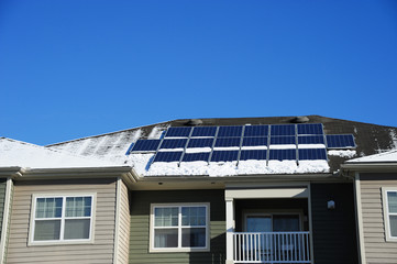 Naklejka premium solar panel on the roof after snow in winter