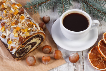 Poppy seeds cake, cup of coffee and spruce branches, dessert for Christmas