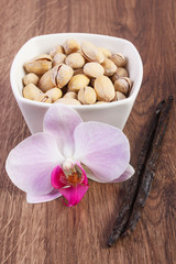 Pistachio nuts, blooming orchid and fragrant vanilla sticks, cosmetic ingredients