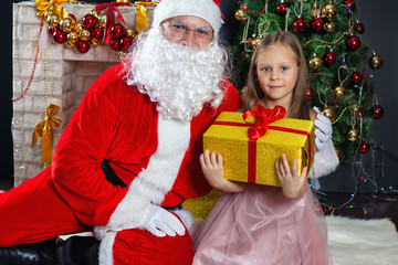 Fototapeta na wymiar Santa Claus and a girl in a dress. Christmas Scenes.