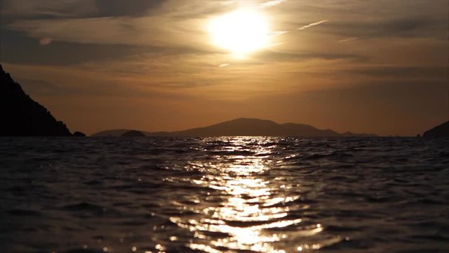 The sun rises over the Greek island of Patmos and the Agean ocean