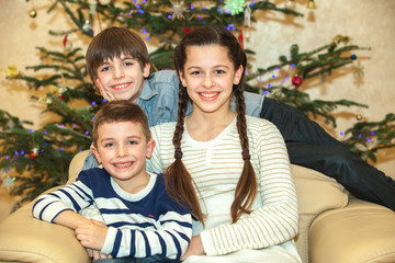 Happy group of children near a Christmas tree