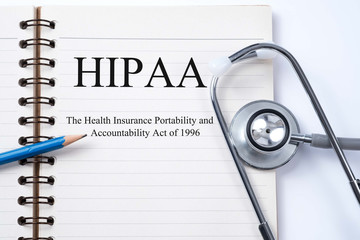 Notebook and pencil with HIPAA (The Health Insurance Portability