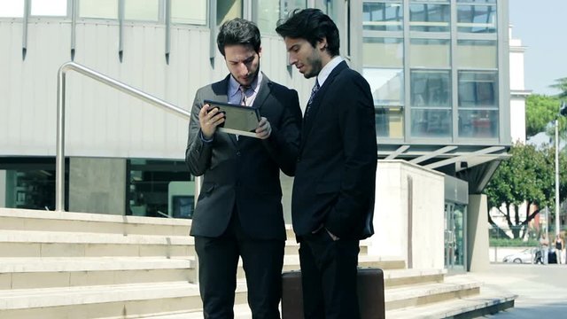 working in  the financial district: business people at work with mobile devices