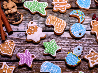 Glazed Christmas cookies on a wooden table serve as a background.