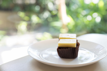 cream cheese brownie with green bokeh background, selective focu