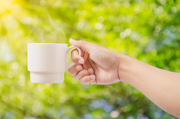 Coffee cup in hand in morning - Powered by Adobe