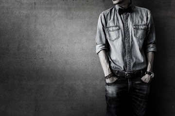 Men's casual outfits standing over grunge background with space, beauty and fashion concept, black...