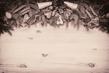 Wooden background with Christmas tree and gingerbread cokies.