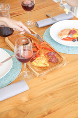 Woman having snack with a glass of sangria