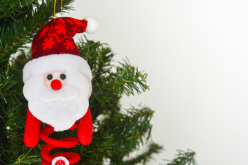 felt santa claus doll hanging on Christmas tree, white background, copy space