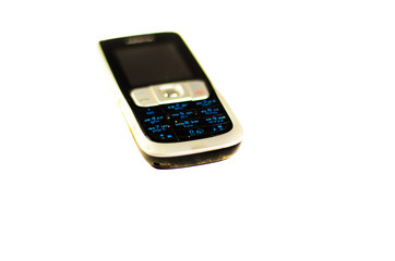Old cell phone isolated on white