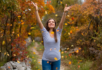 Beautiful pregnant caucasian woman in autumn