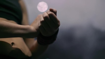 Beautiful woman put sports bandage on her hand in the gym strength fit body 