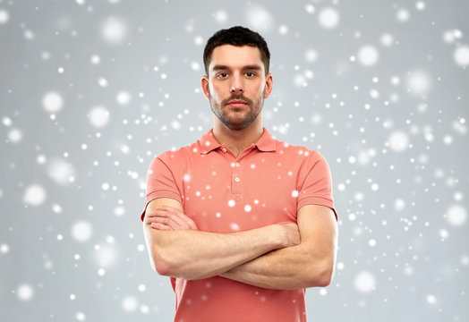 Young Man With Crossed Arms Over Snow Background