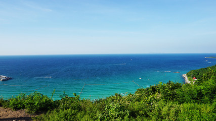Fototapeta na wymiar Sea view from tropical beach with sunny sky. Summer paradise bea