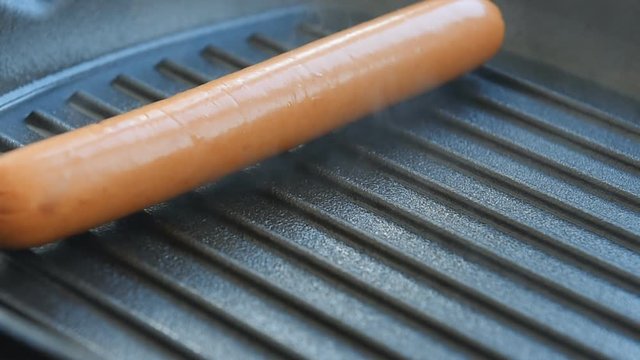 Cooking sausages on the grill