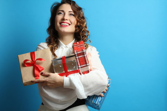 Portrait Of A Happy Girl With Lots Of Gifts Boxes In Hands.