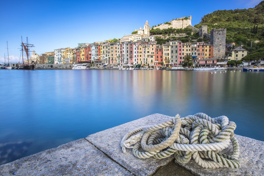 View from the pier of blue sea which frames the typical colored houses of Portovenere, La Spezia Province, Liguria