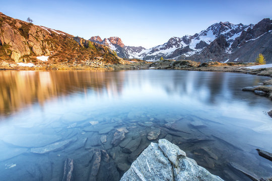 Snowy peaks reflected in Lake Zana at sunrise, Malenco Valley, Valtellina, Province of Sondrio, Lombardy