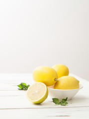 lemons and mint on white wooden table