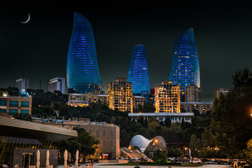 Moon and Flame Towers skyscraper at night in Baku,  Azerbaijan. - 129648861