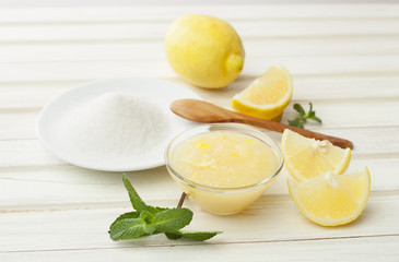 cosmetics homemade lemon, ginger, sugar and essential oils  on w