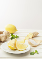 cosmetics homemade lemon, ginger, salt and essential oils  on wh