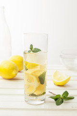 Lemonade with fresh lemon on white