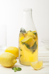 Lemonade with fresh lemon on white