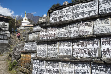 Mani stones inscribed with an ancient Buddhist mantra decorate the trail to Everest Base Camp, Khumbu Region, Nepal, Himalayas