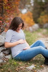 Beautiful pregnant caucasian woman in autumn