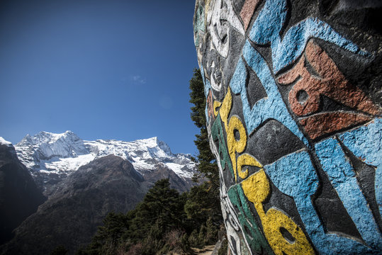 A Mani wall, inscribed with an ancient Buddhist mantra decorates the trail to Everest Base Camp, Nepal, Himalayas