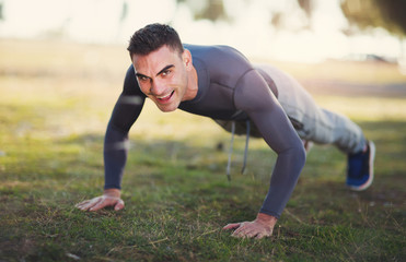 Handsome man exercising in forest