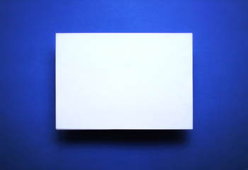 Empty white paper sheet blue background