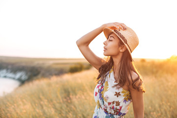 indian woman in golden field with summer dress