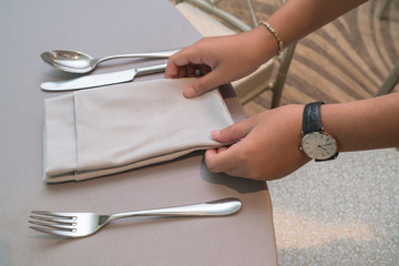 Waiter hand place dishes on the table, meal preparation
