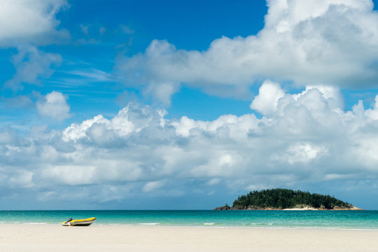 A small dinghy sits on the white sand of Whitehaven Beach, Whitsunday Island
