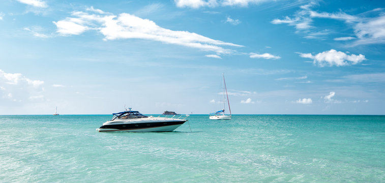 Fototapeta Attractive bright view of exotic colorful beautiful marine beach with boat on blue water