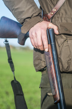 Hunting rifle in hunters hand