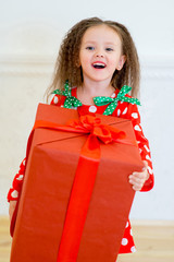 Happy little girl with christmas gift box