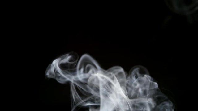SLOW MOTION: Tabacco smoke on a black background