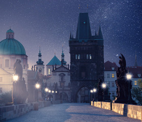 Prague, Czech Republic. Charles Bridge with its statuette at night, Old Town Bridge Tower in the...