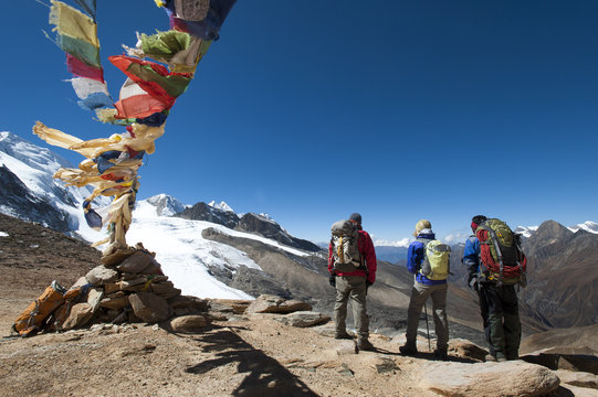 A windy prayer flag strewn cairn marks the top of the Kagmara La, the highest point in the Kagmara Valley at 5115m, Dolpa Region, Himalayas, Nepal